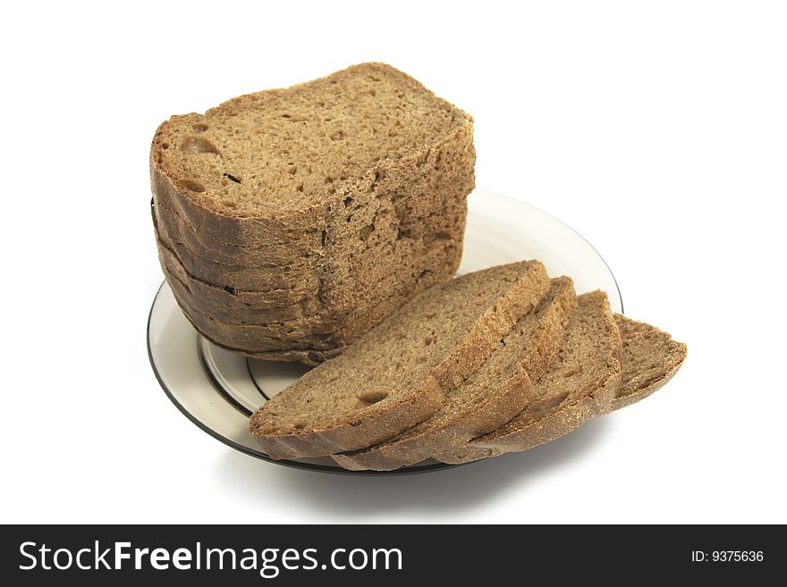 Dark bread on glass plate isolated on white