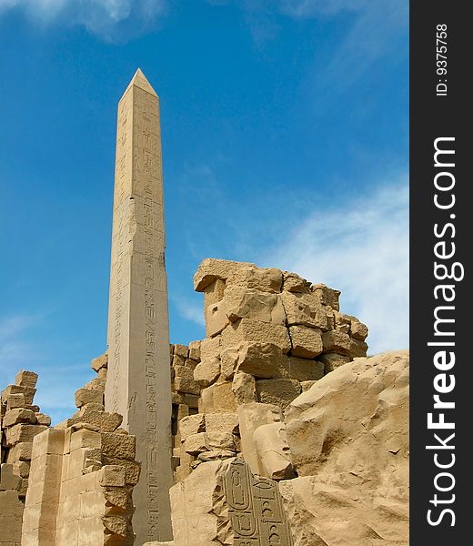 One of granite needles of queen Hatshepsut (woman the pharaoh) on territory of Karnak temple complex. Ancient Thebes. Luxor, Egypt. One of granite needles of queen Hatshepsut (woman the pharaoh) on territory of Karnak temple complex. Ancient Thebes. Luxor, Egypt.