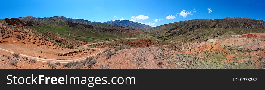 Road to gorge through red hills