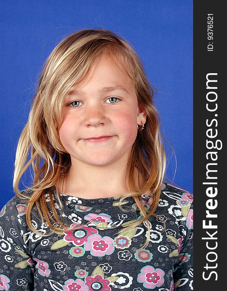 Portrait of cute blond girl on blue background