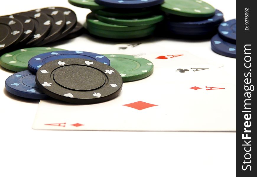 Four aces and casino chips isolated over white