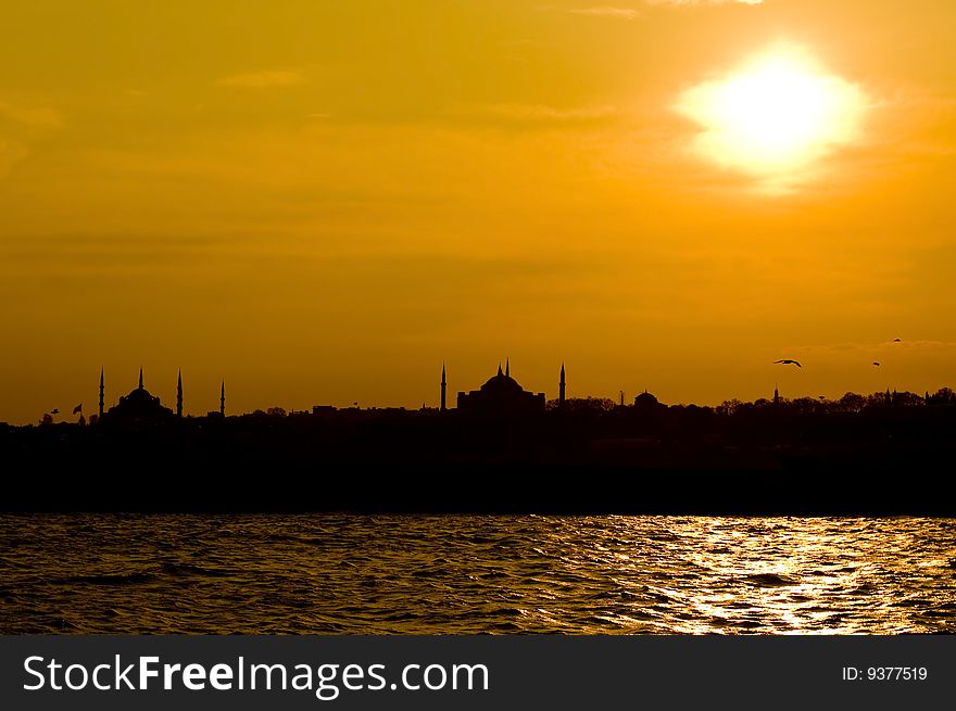 The view of Blue mosque and Hagia Sofia after sunset from Uskudar