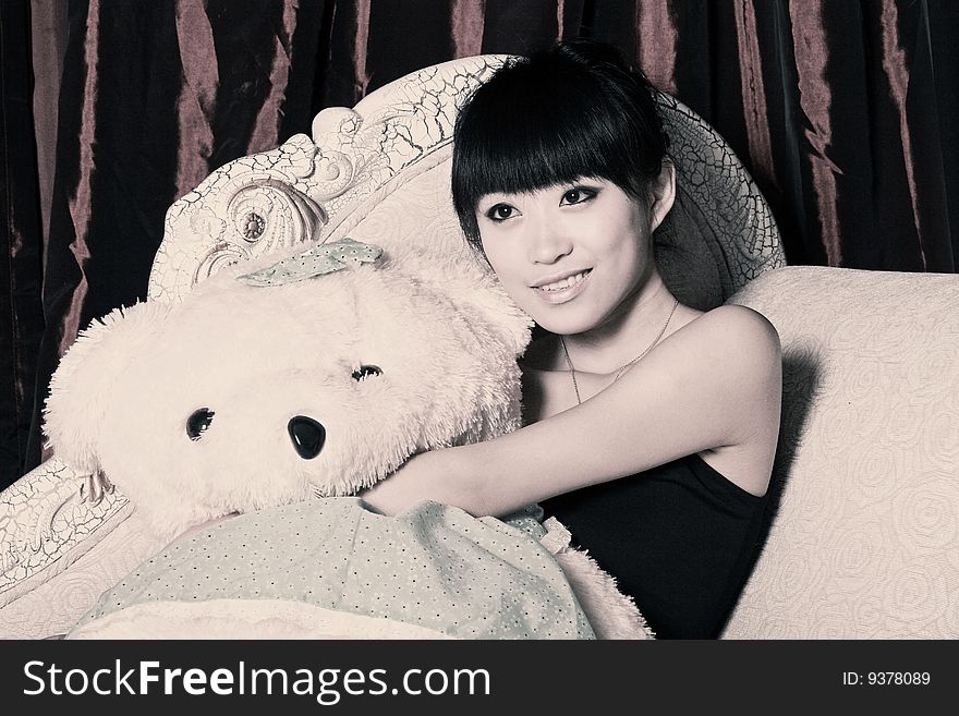 A Asian girl is holding the teddy bear and watching TV .

The tone is adjusted on later stage. A Asian girl is holding the teddy bear and watching TV .

The tone is adjusted on later stage