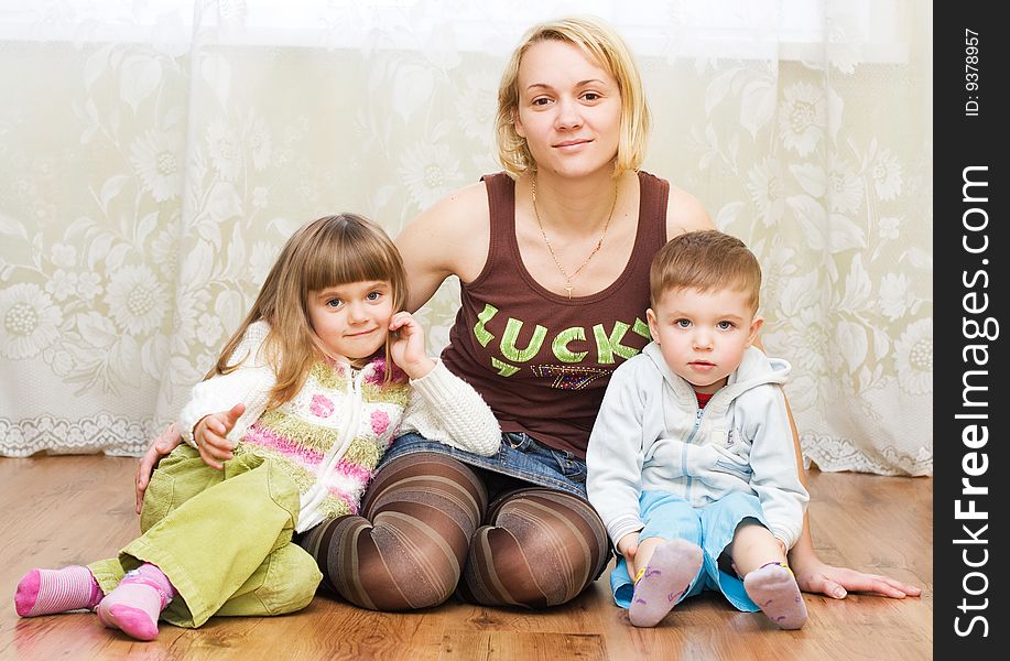 Mother with son and daughter on a floor