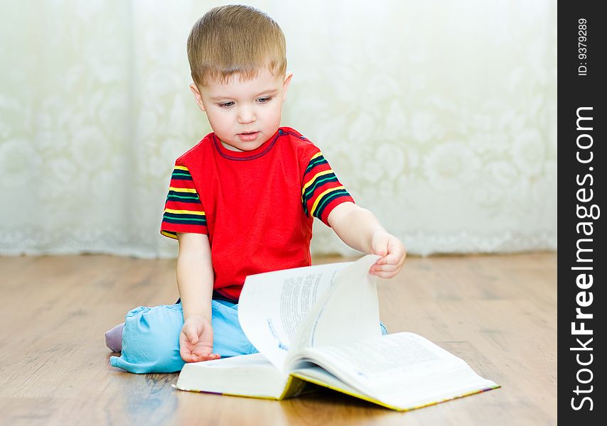 A little boy reads a book