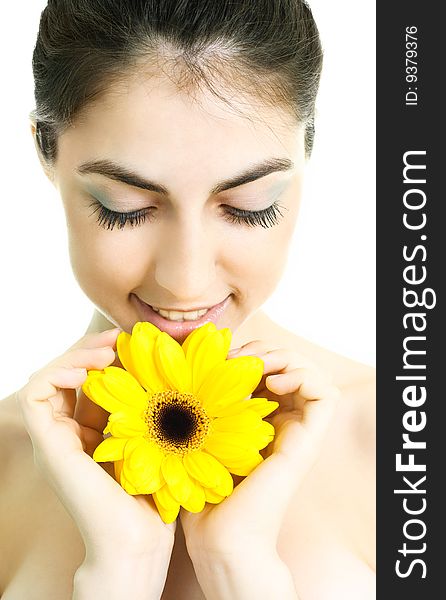 Pretty young brunette woman with a yellow flower. Pretty young brunette woman with a yellow flower