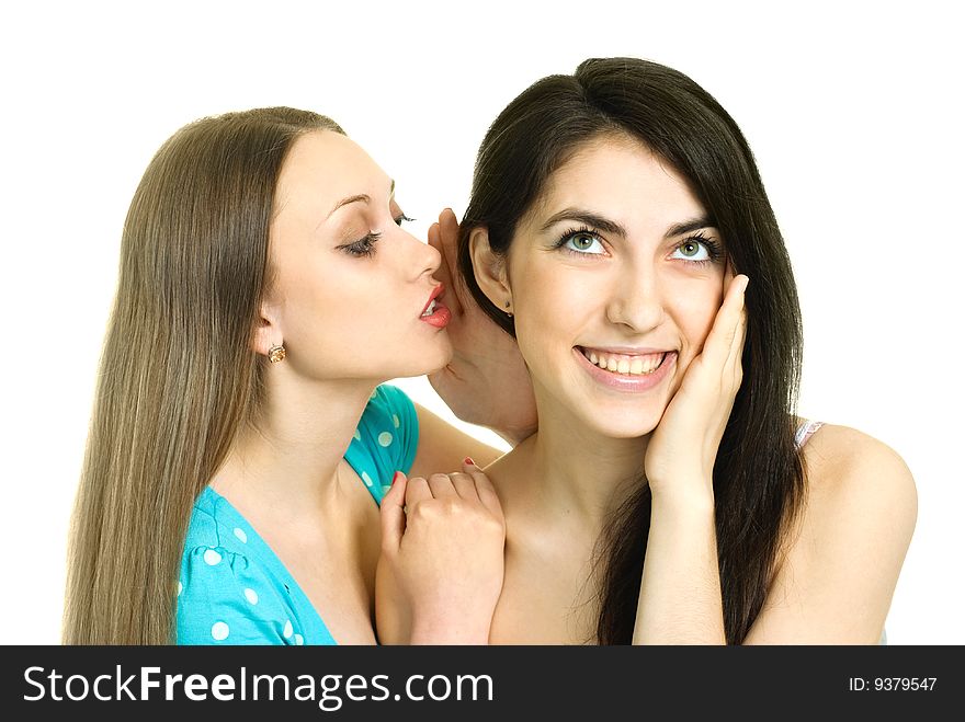 Portrait of two beautiful gossiping girls against white background. Portrait of two beautiful gossiping girls against white background