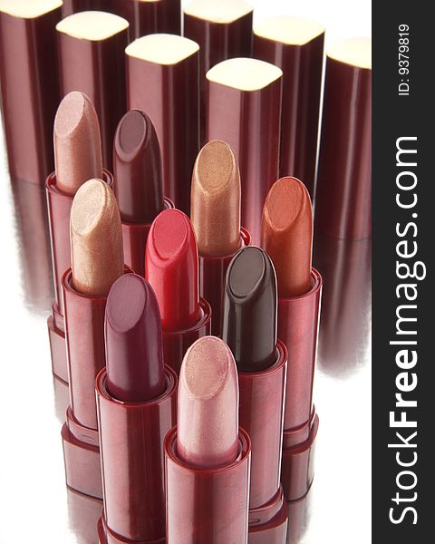 Group of multi-coloured lipsticks on a white background