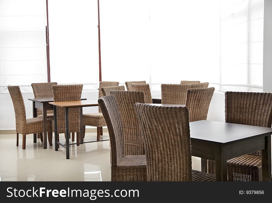 Room with empty wood chairs and tables