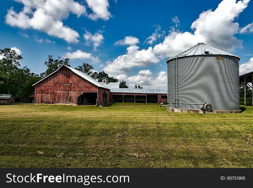 Gray Metal Water Tank Under Clear White Blue Sky during Daytime