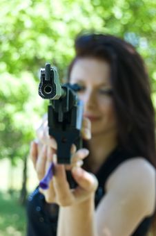 Woman Aiming Pneumatic Gun Royalty Free Stock Image