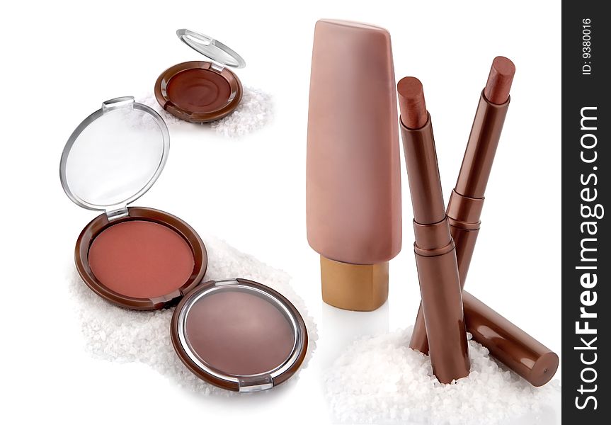 Makeup set: powder, cream, lipstick on a white background