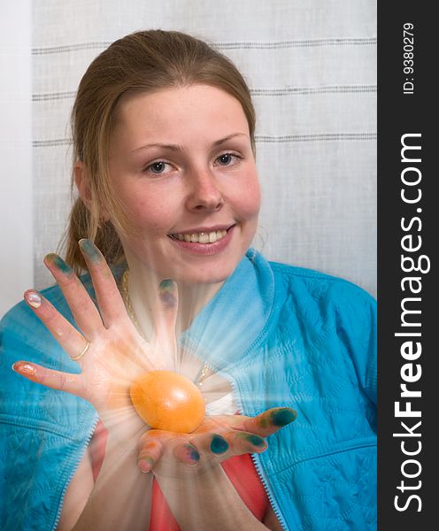 Woman carring shining Easter egg in her hands
