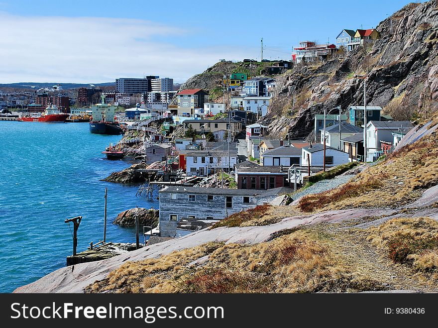 A view of a coastal village built along a narrow, rocky shoreline. A view of a coastal village built along a narrow, rocky shoreline.