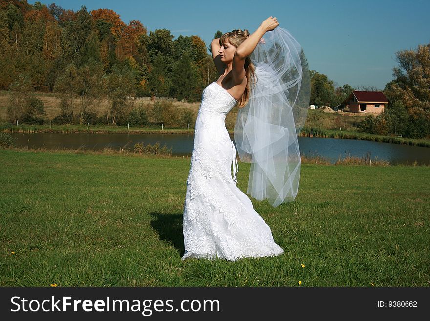 Bride walking with bridal veil flying with the wind. Bride walking with bridal veil flying with the wind