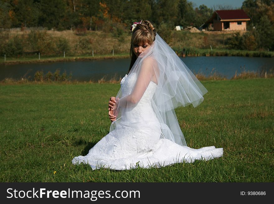 Beautiful Bride Sitting On A Meadow