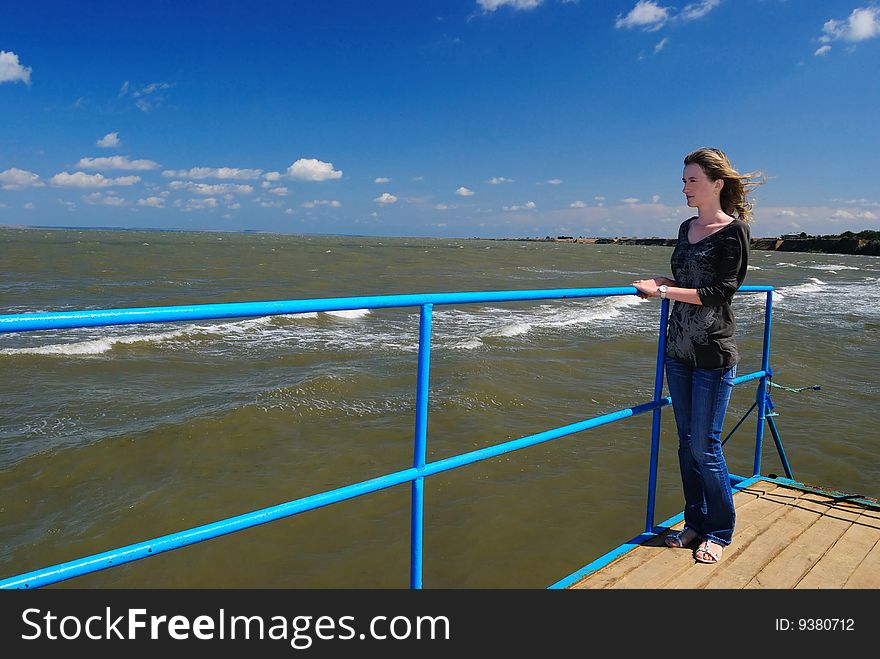 The girl near the sea. Strong wind. The girl near the sea. Strong wind