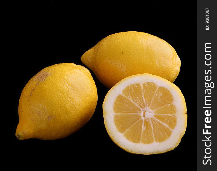 Lemons and flowers isolated on black