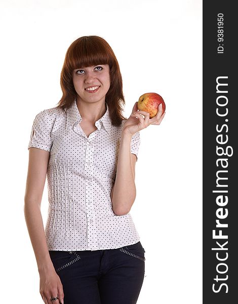 The young red girl holds an apple on a white background. The young red girl holds an apple on a white background