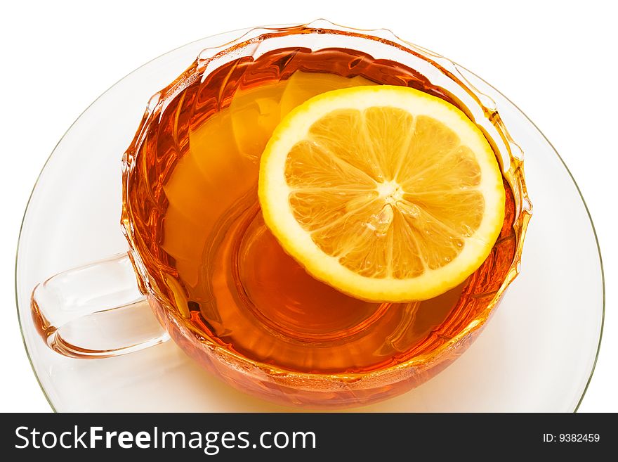 Glass cup with tea and a lemon on a white background