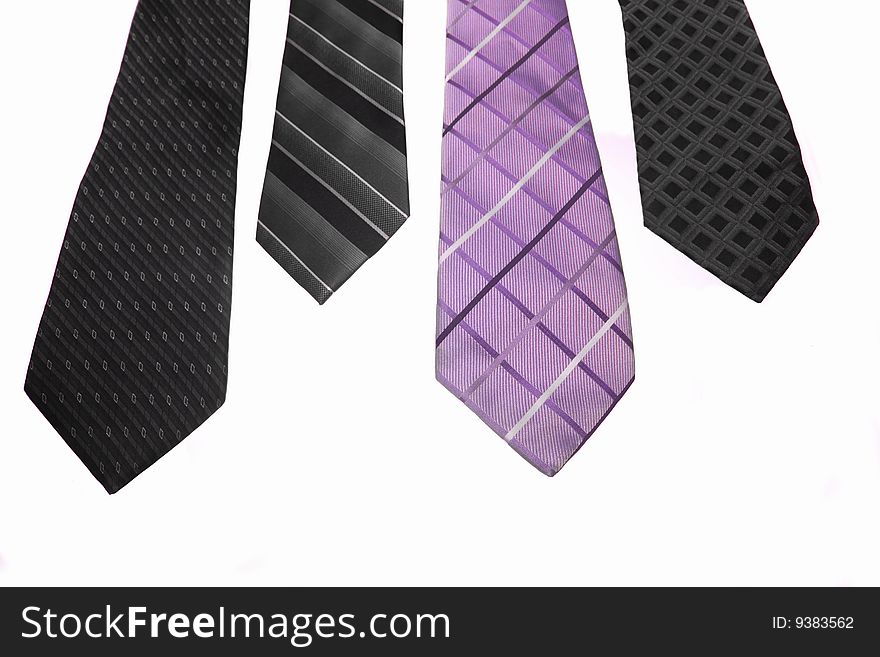 Four colorful ties hanging on white background