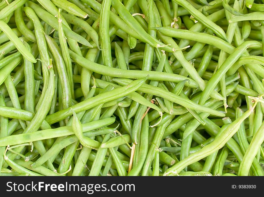 Close up on some green beans for sale.