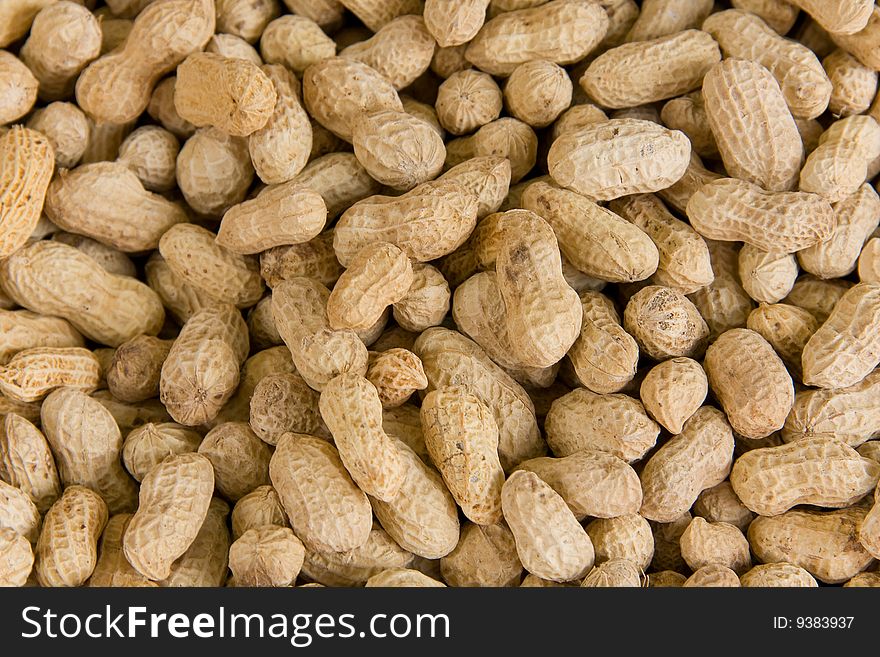 Close up on a huge pile of peanuts.