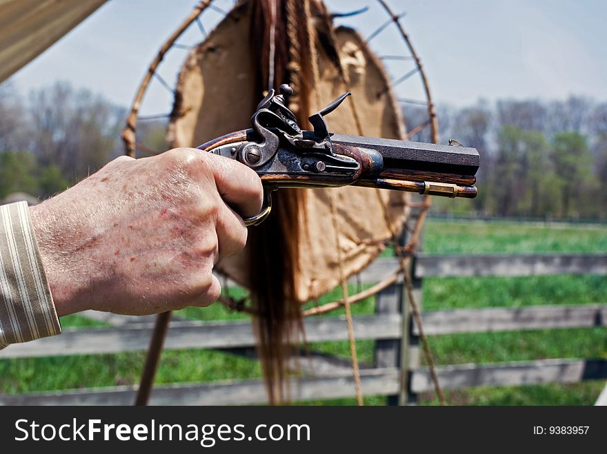 Man aiming a vintage pistol. Man aiming a vintage pistol.