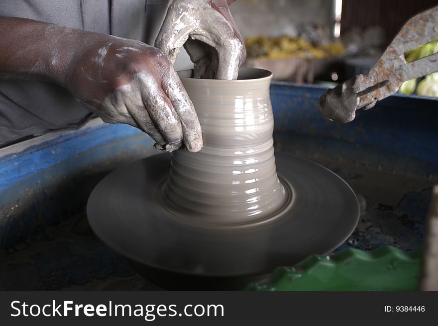Kenya, hands working a ceramic vase. Kenya, hands working a ceramic vase