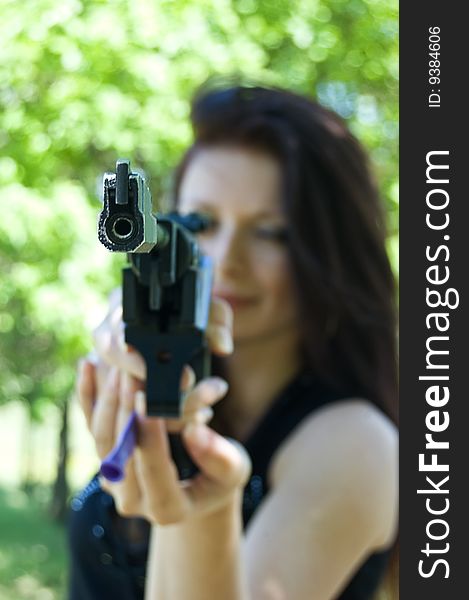 Woman aiming pneumatic gun