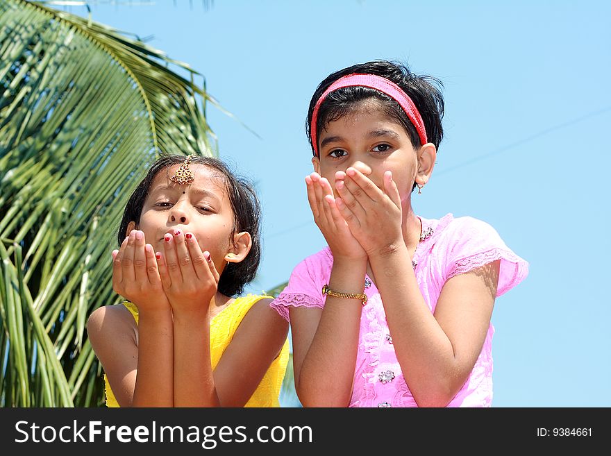 A two girls raising their hands to express extreme wonderment. A two girls raising their hands to express extreme wonderment.