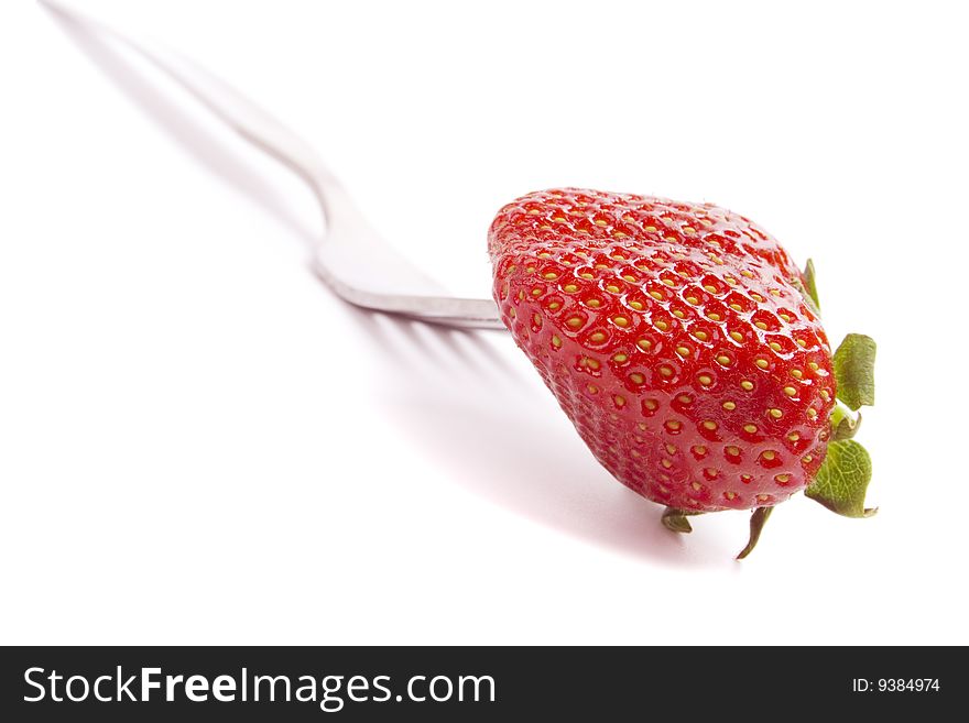 Fork and fresh strawberry isolated on white background