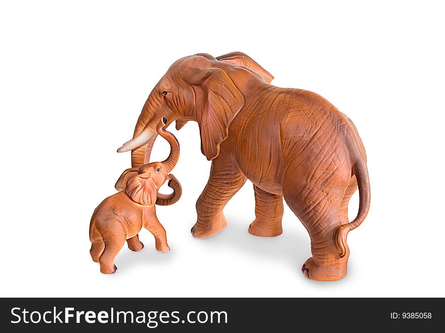 Figurines of an elephant cow and elephant calf are photographed on a white background. Figurines of an elephant cow and elephant calf are photographed on a white background