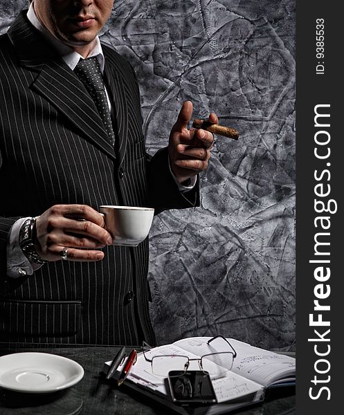 Businessman with a cigar and coffee