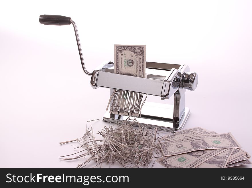 Pasta machine is waisting dollars against a white isolated background with copy-space. Pasta machine is waisting dollars against a white isolated background with copy-space