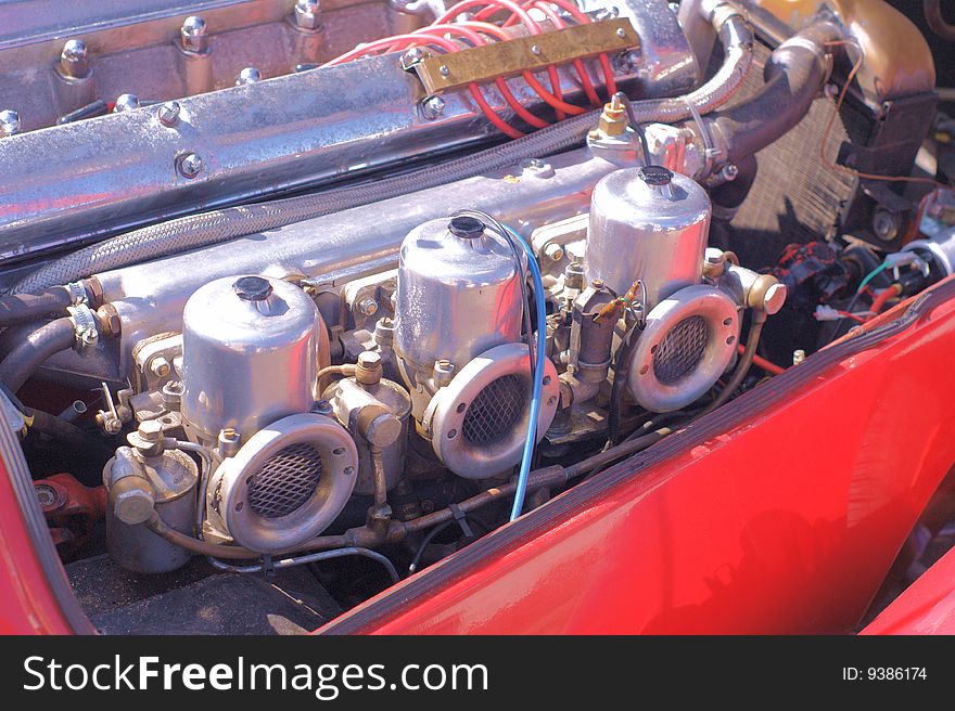 Showing the triple carburetors on an old sports car. Showing the triple carburetors on an old sports car