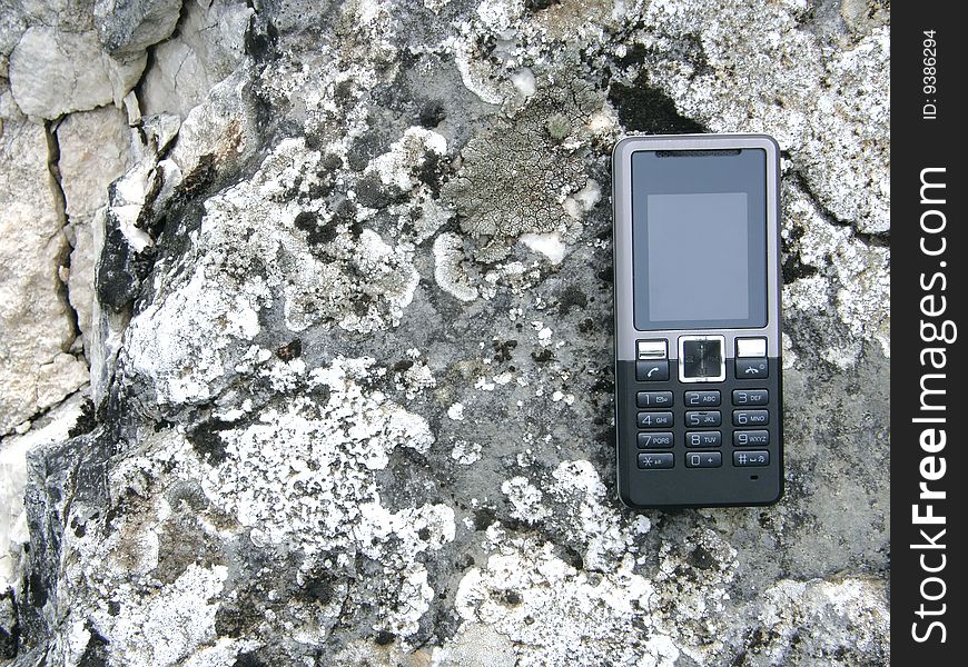 Cellular phone on the rock