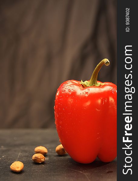 Red paprika with almonds on the table