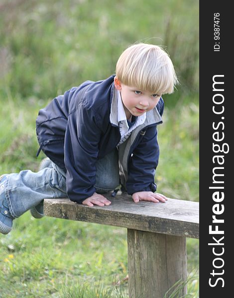 Small boy climbed the bench