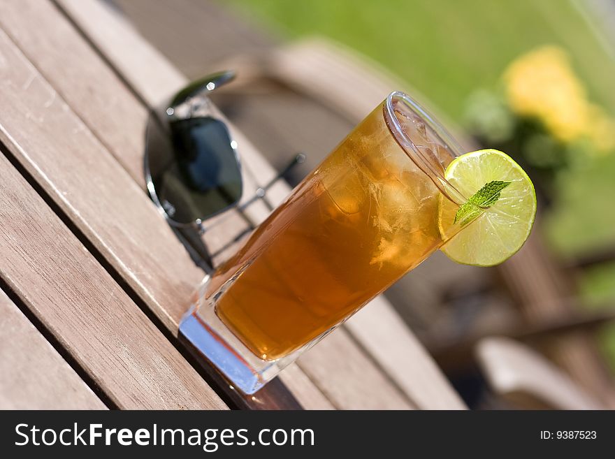 Ice tea on the table with forgot sunglasses