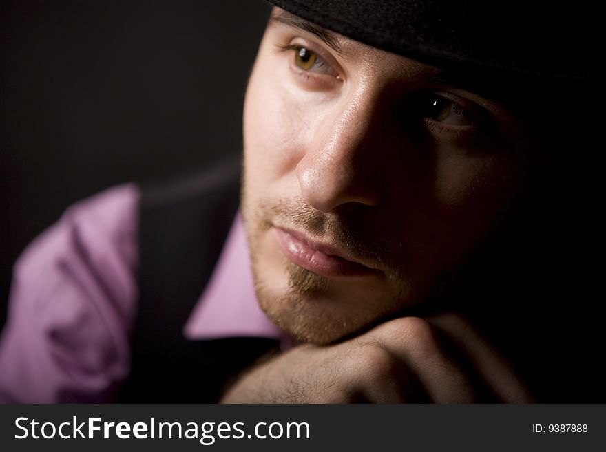 Young man in pink shirt on black floor