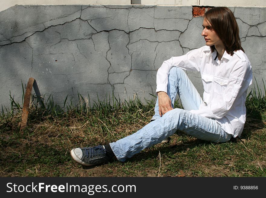 Nice man sitting near wall