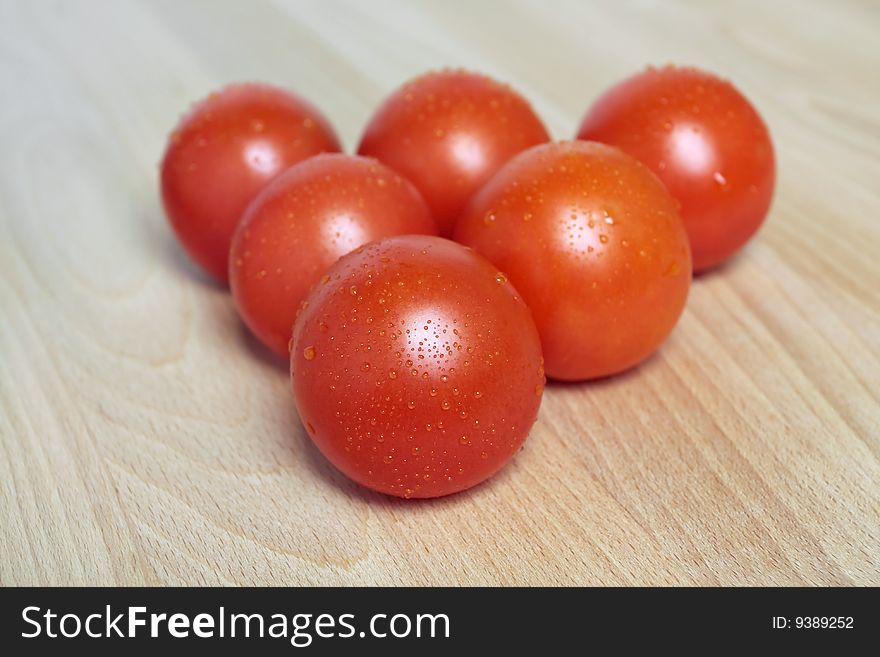 Fresh tomatoes on wooden  chopping board closeup