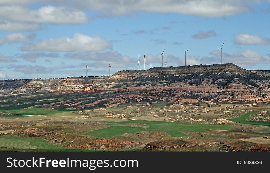 Wind turbines against the sky in fields of Spain
