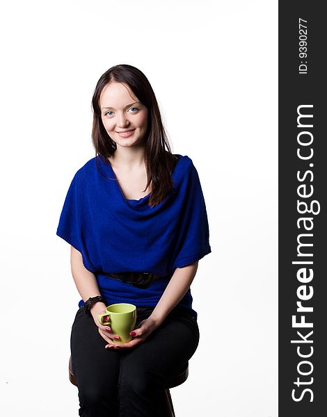 The young smiling girl with a tea cup. The young smiling girl with a tea cup