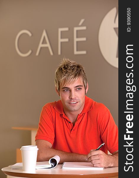 Portrait of male student taking a coffee break.