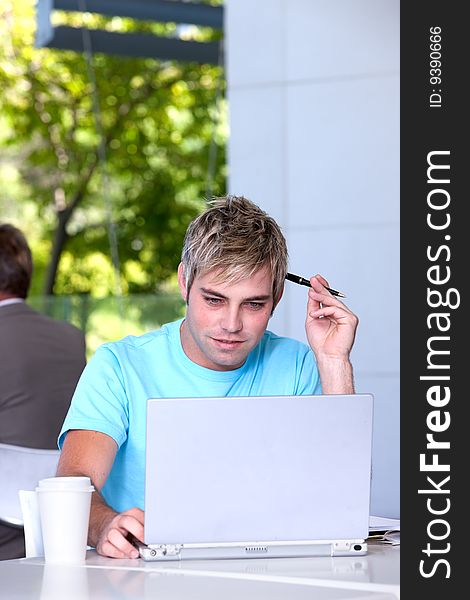 Portrait of male student working on laptop. Portrait of male student working on laptop.