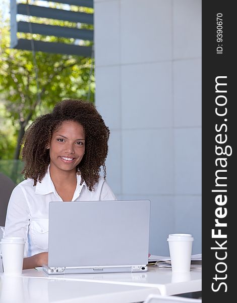 Portrait of female student working on laptop. Portrait of female student working on laptop.