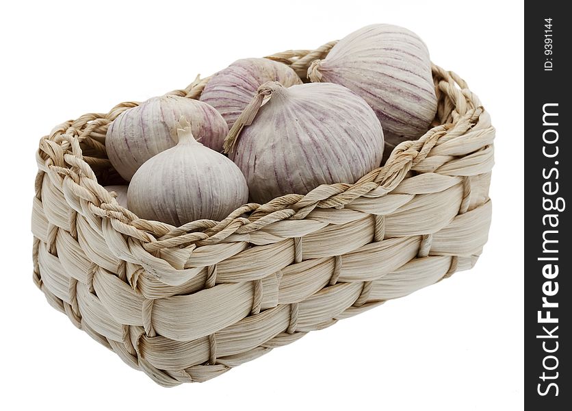 Garlic in little basket, isolated against a white background