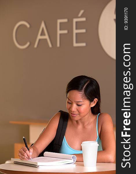 Portrait of female student taking a coffee break.